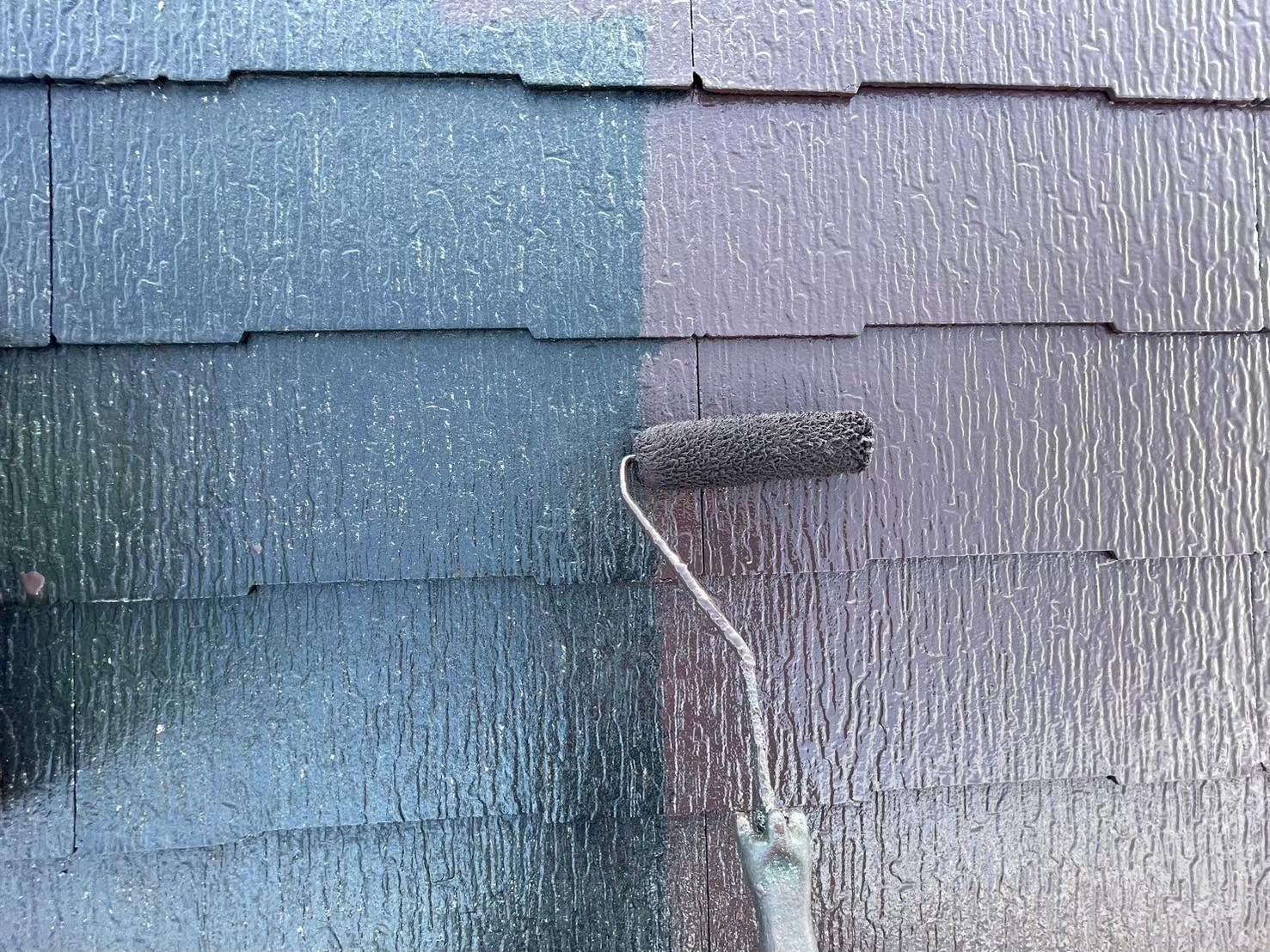 黒いスレート屋根に上塗り材を塗装